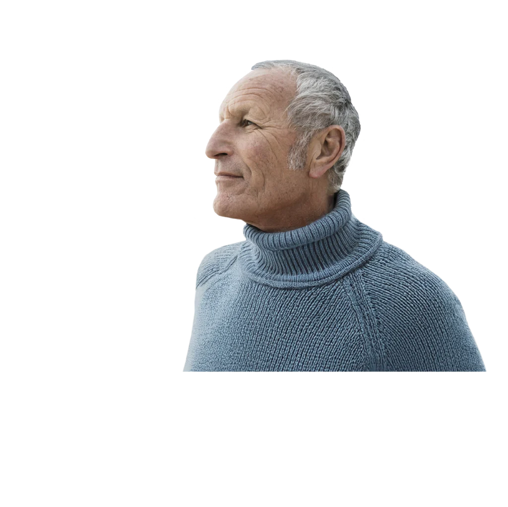 Older man in light blue turtleneck sweater confidently looks off into the distance.
